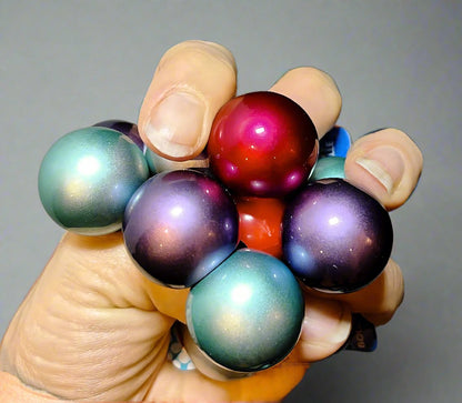 Atomic Fidget balls in metallic colours (purple, pink, teal)